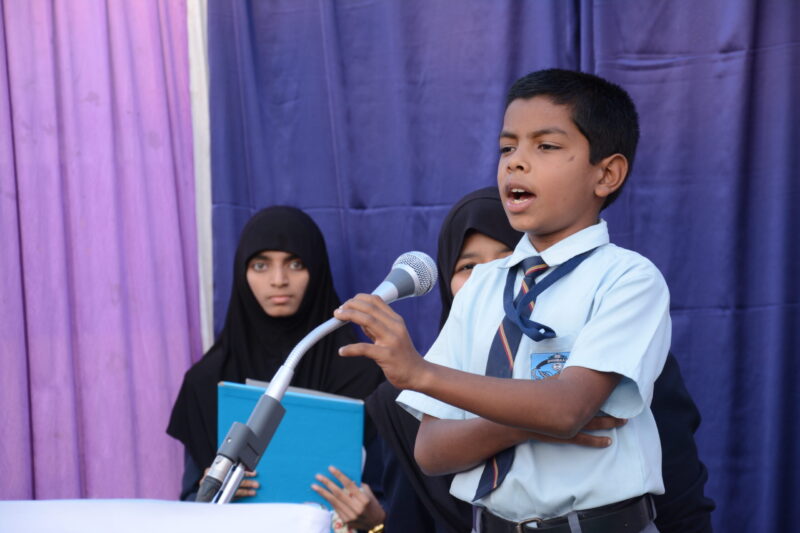 A boy reciting at Shahbaaz school and PU college