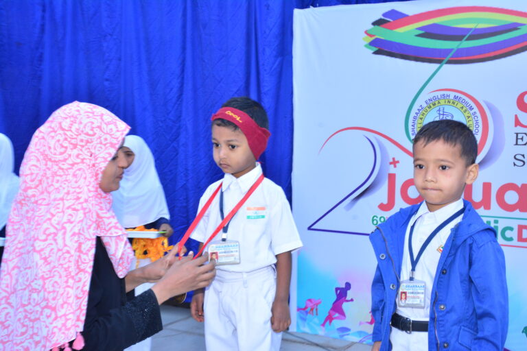 A kid awarded with medal from his teacher on republic day at Shahbaaz school and PU college Gulbarga