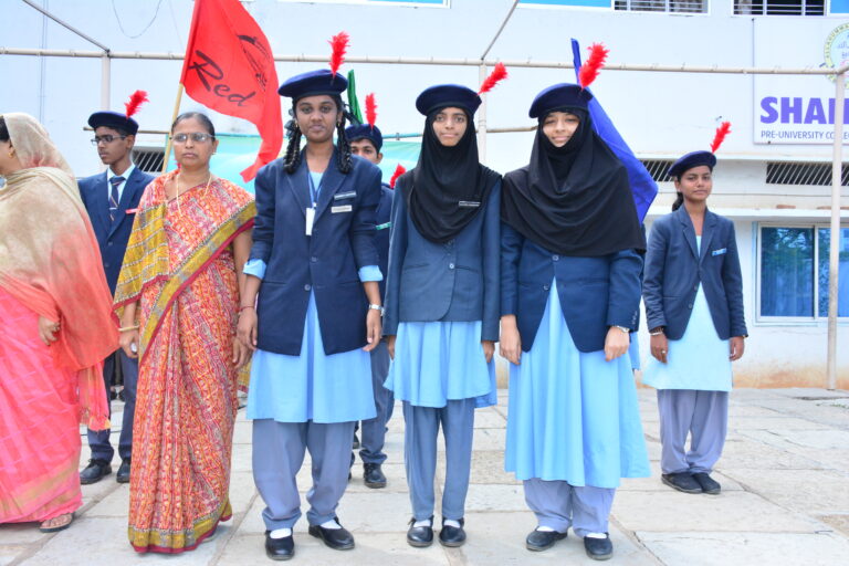 Three girls in attention position at Investiture ceremony at Shahbaaz school and PU college Gulbarga