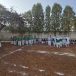 House Green Sports Representatives in the Shahbaaz school playground behind the school building.