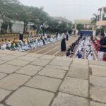 Class V and VI students patiently waiting in the Shahbaaz School playground in neat rows for their games to begin.