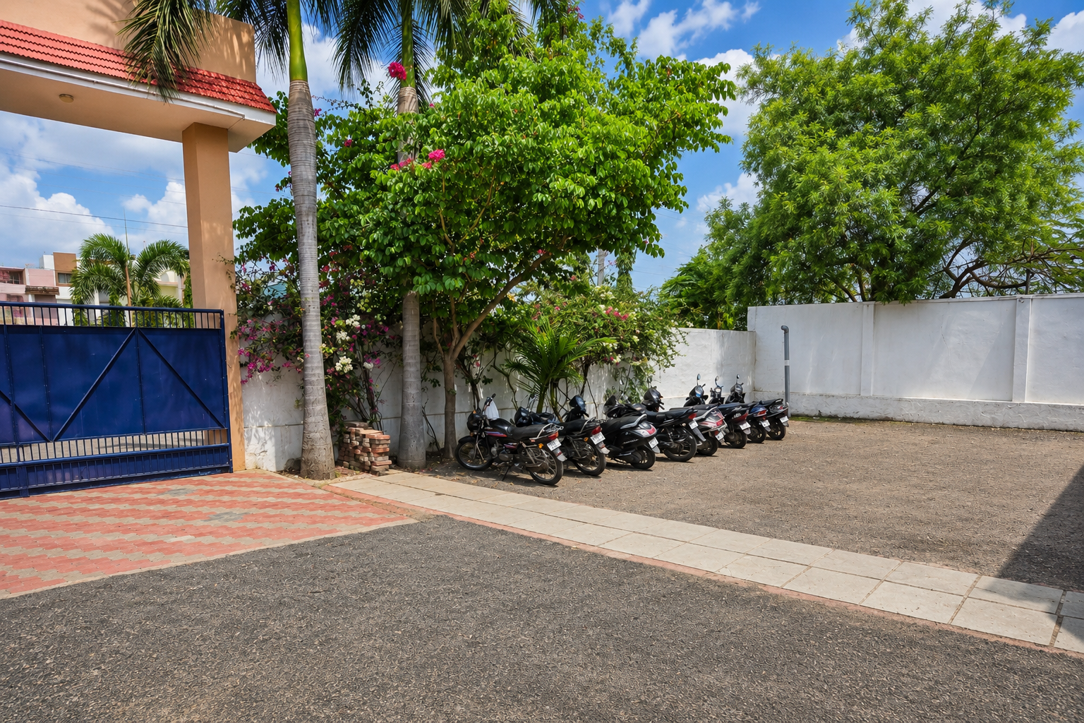 Vehicle parking space at Shahbaaz school to the left of the entrance gate.